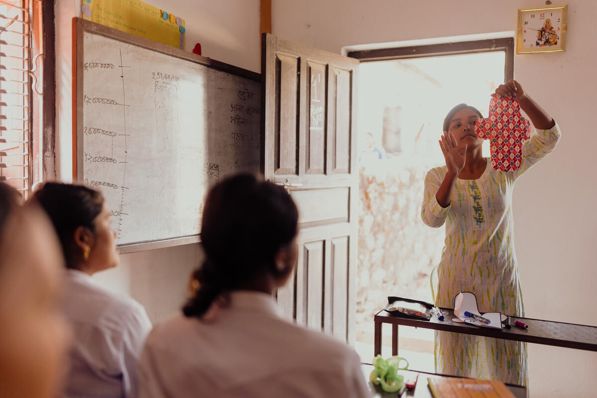 Susma teaching the youths how to make sanitary pads.